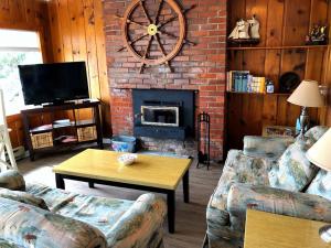 Anchor's Away living room with dining table and wood stove